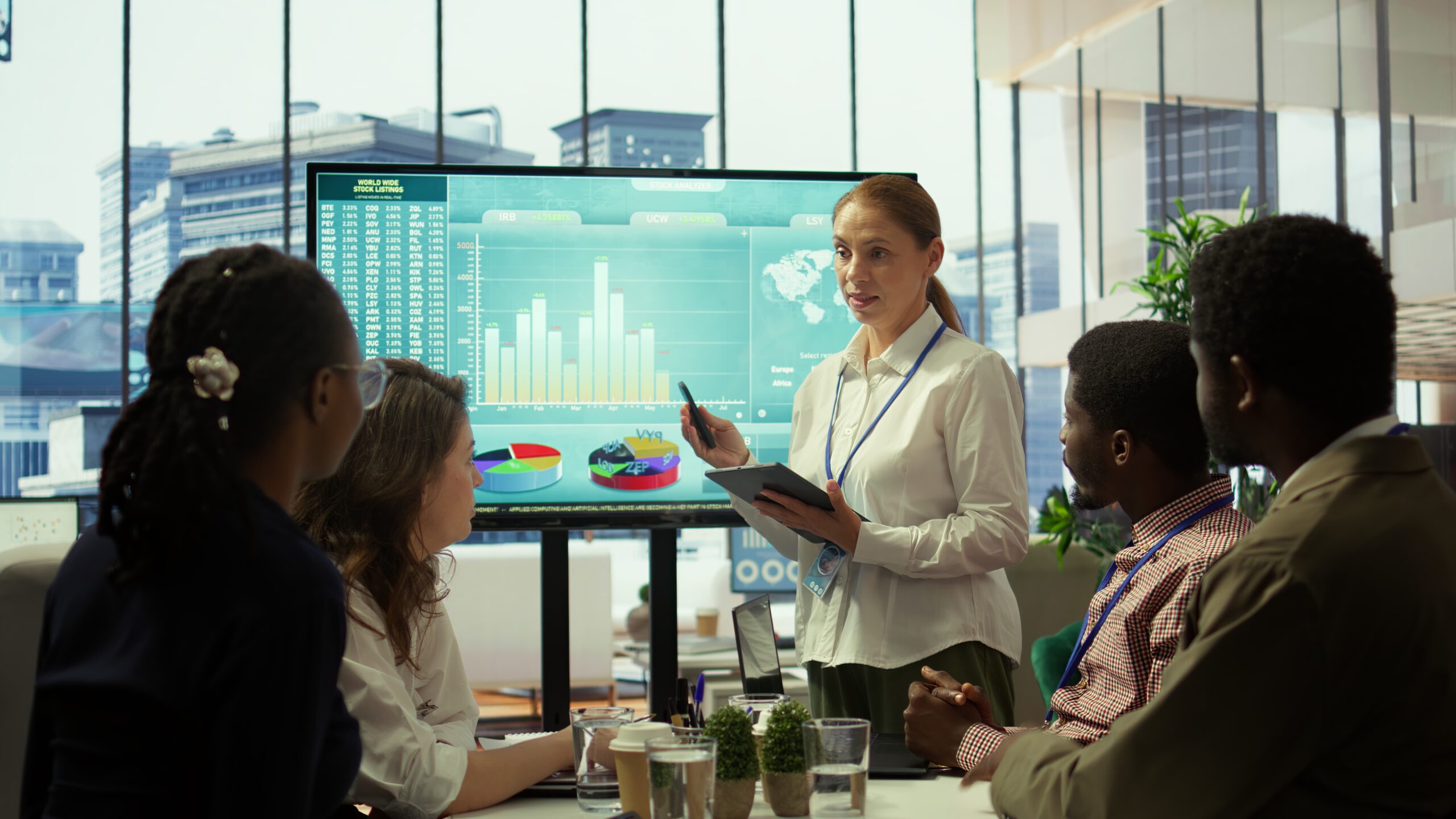 Group of business associates discussing project development plans, leveraging big data and advanced analytics to make informed decisions and enhance workflow. Multinational company. Camera B.